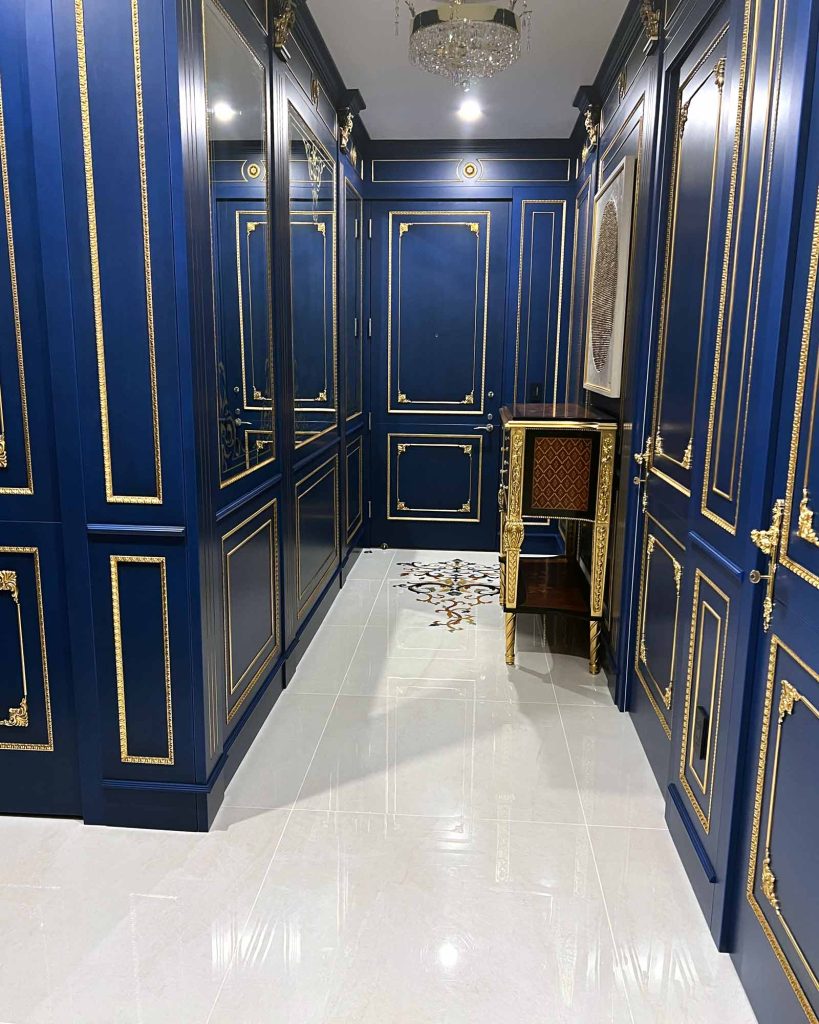 A royal blue hallway renovation with gold detailing