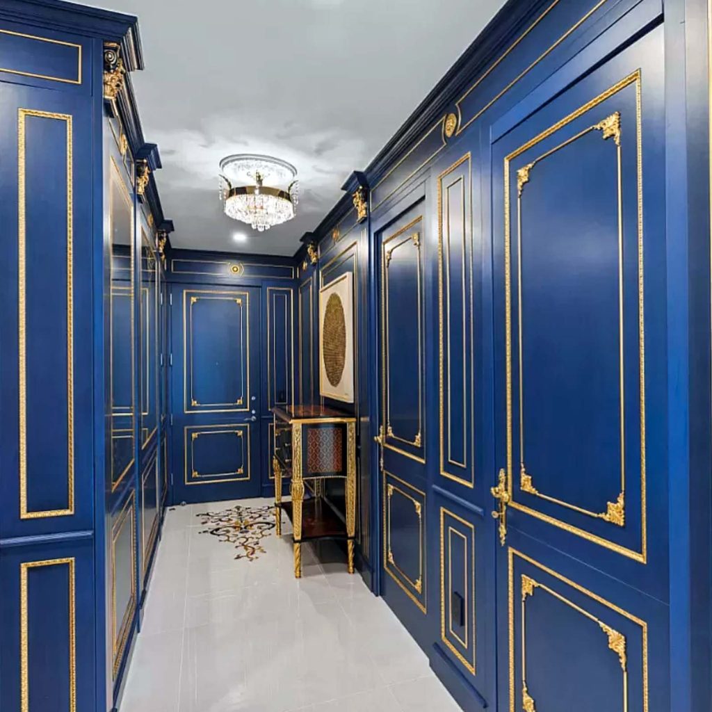Royal blue hallway with gold finishings