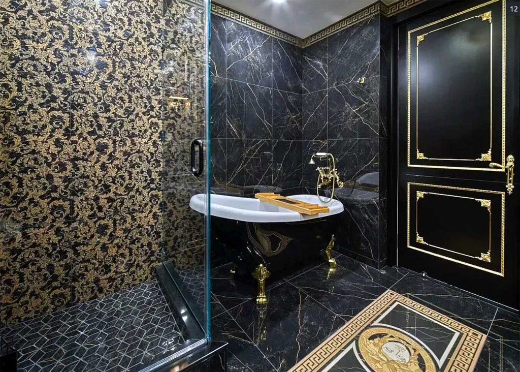 A dark, luxurious bathroom remodel with royal detailing