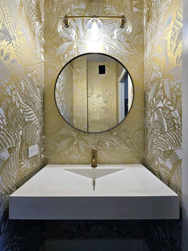 A luxury bathroom remodel with gold leaf wallpaper