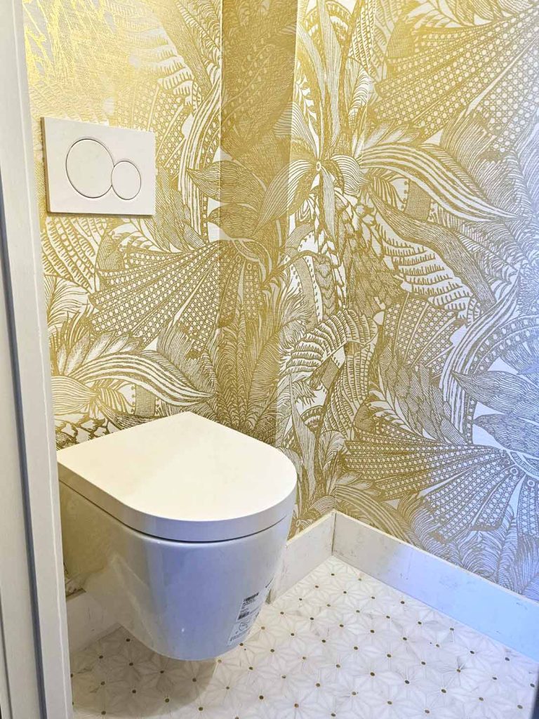 A bright bathroom renovation with luxury gold leaf