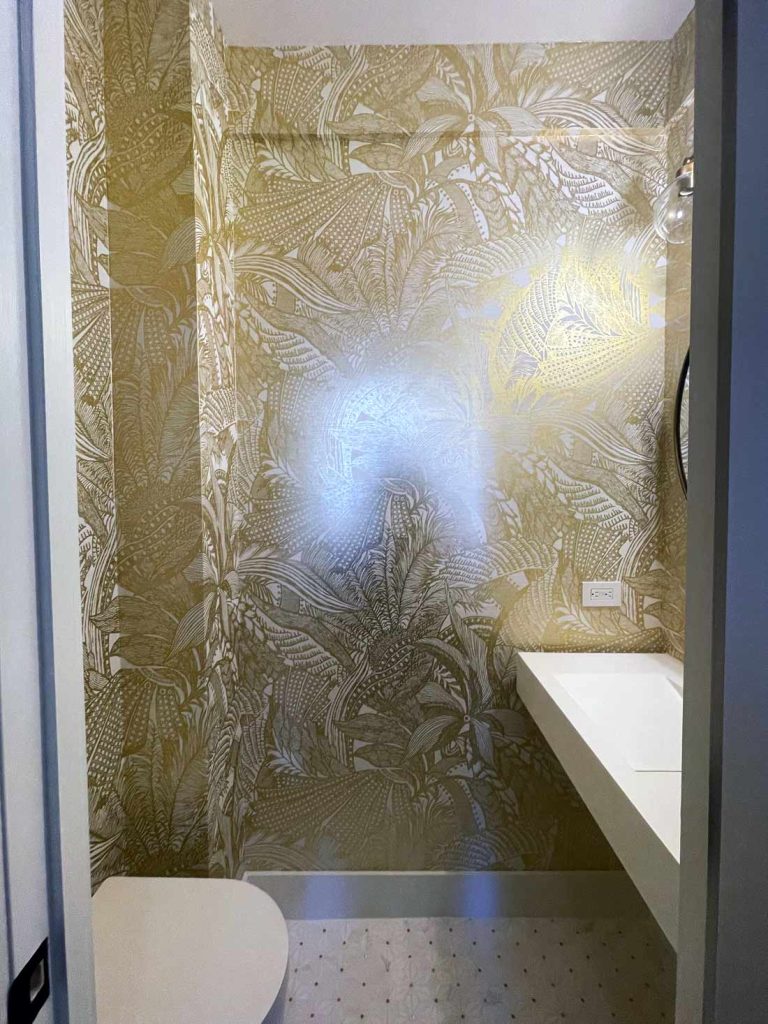 An elite bathroom remodel with gold leaf