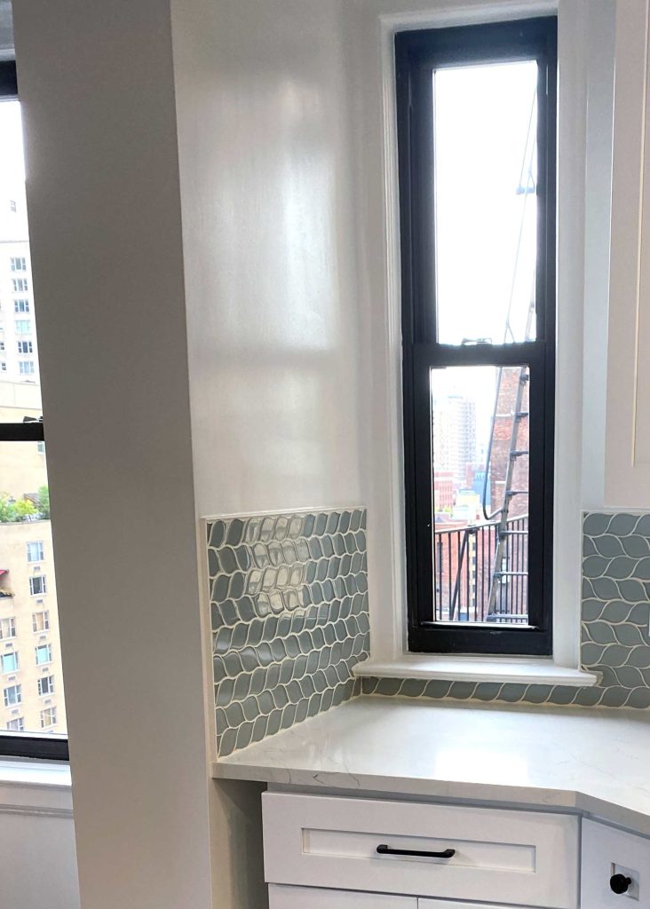 A slim window with interesting kitchen tile
